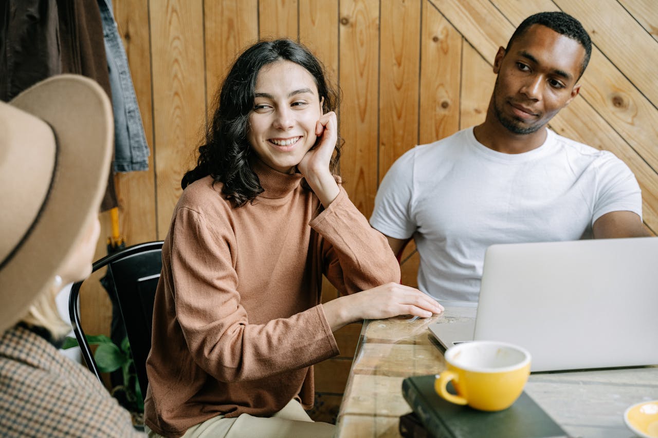 Three professionals collaborating in a cozy office setting, fostering teamwork.